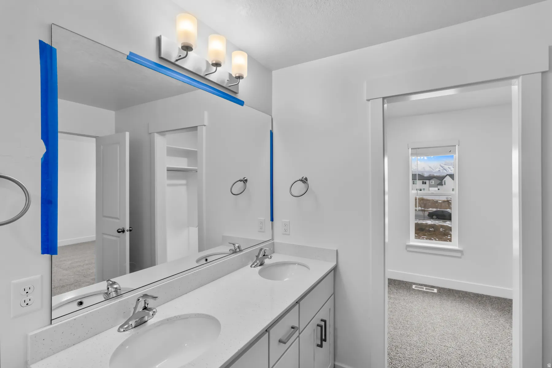 Double vanity with integrated sinks and a light-toned countertop