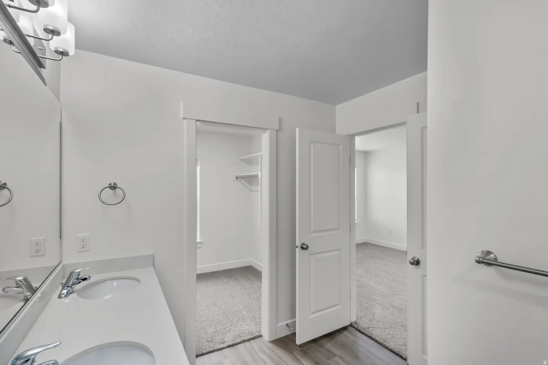 Double vanity with integrated sinks and chrome fixtures