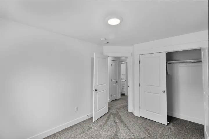 Plush carpeting and a built-in closet with sliding doors