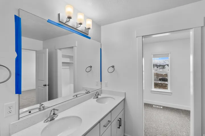 Double vanity with integrated sinks and a light-toned countertop