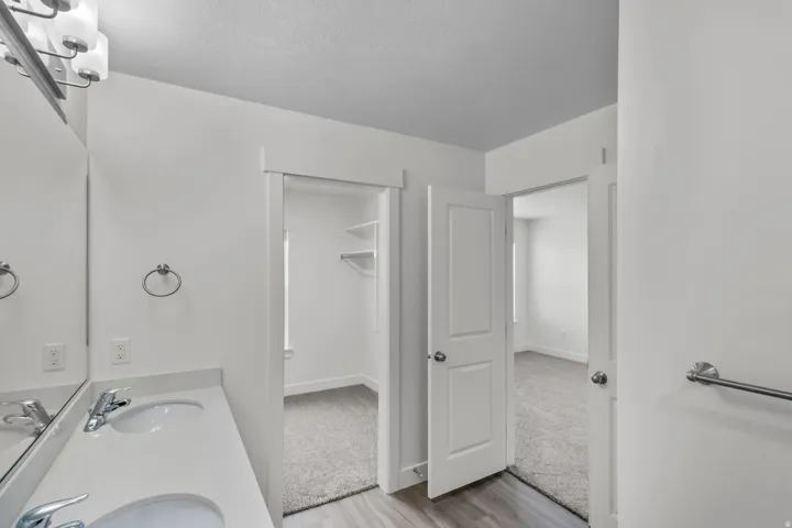Double vanity with integrated sinks and chrome fixtures