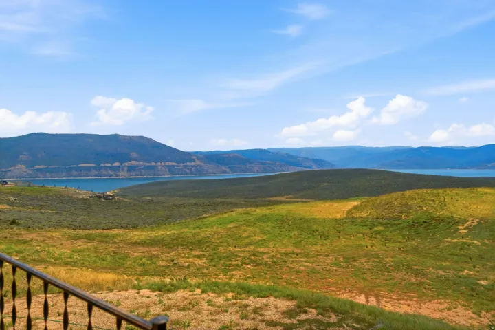 Expansive landscape featuring distant mountains and a large body of water