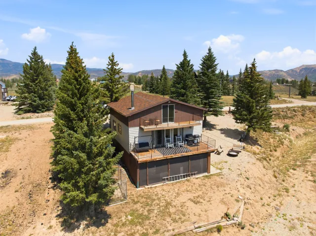 Two-story residential structure featuring a lower-level deck and an upper-level balcony