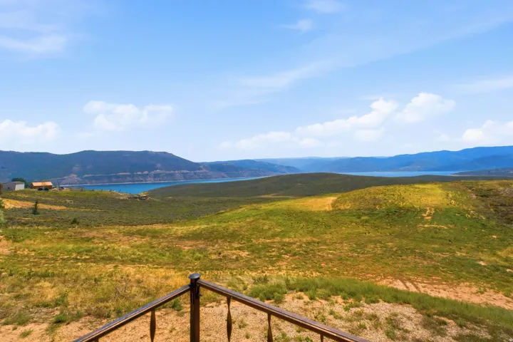 Expansive hilltop grounds offering panoramic vistas across rolling terrain toward distant mountains and waterfront