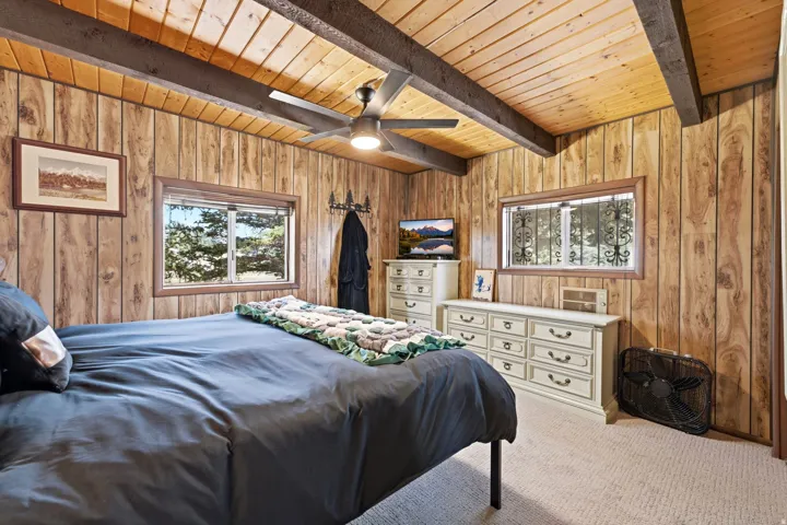 Wood-paneled walls and ceiling with exposed wood beams
