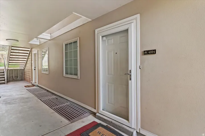 Covered entryway with neutral-toned walls, recessed lighting, and skylight flooding the space with natural light