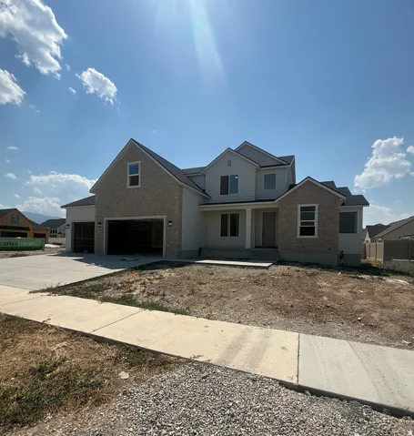 Two-story property with light-colored siding and stone-finish accents