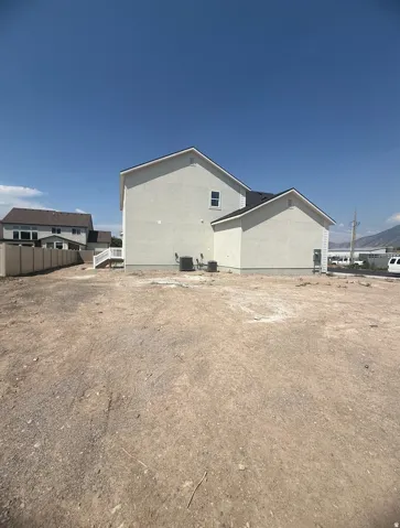 Stucco exterior with a pitched roof and a multi-level design