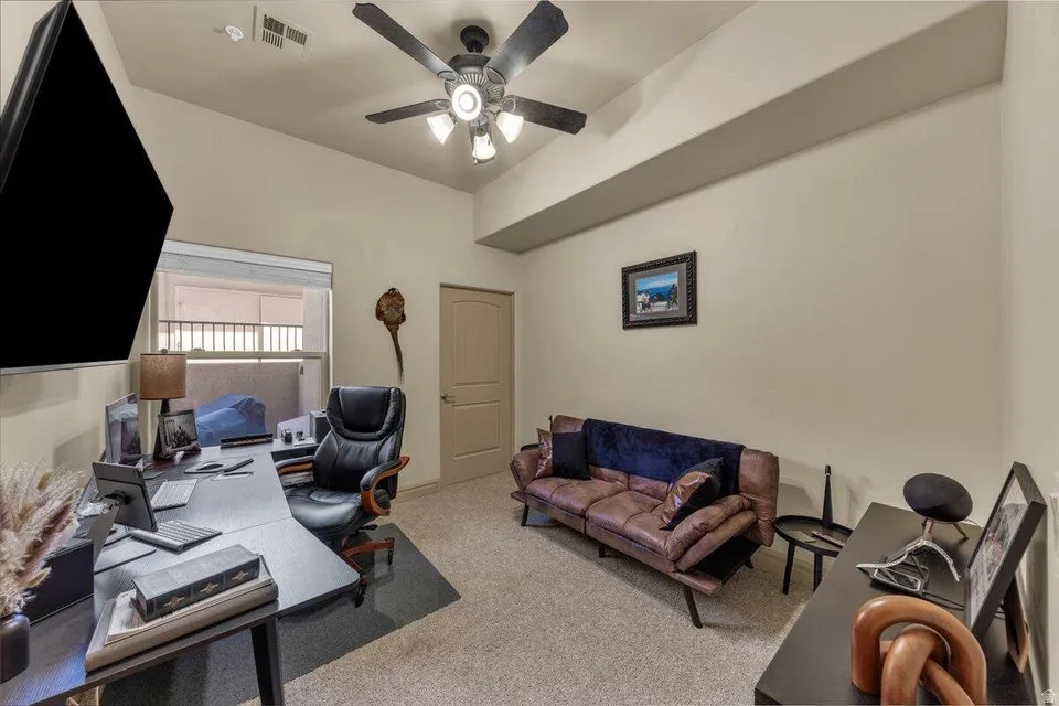 Recessed lighting, ceiling fan with integrated light fixture, window with blinds, interior door, and neutral wall tones