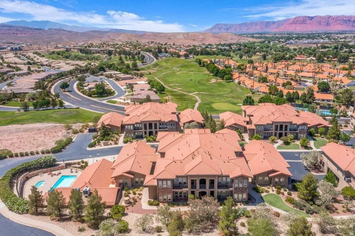 Sprawling estate featuring a terracotta tile roof, arched architectural detailing, and multiple residential pavilions set across manicured grounds
