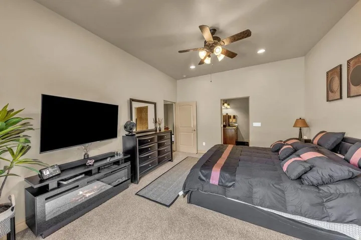Vaulted ceiling with a ceiling fan and recessed lighting