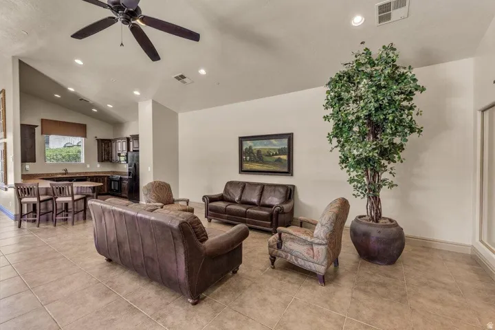 Vaulted ceiling with a ceiling fan, recessed lighting, and tile flooring