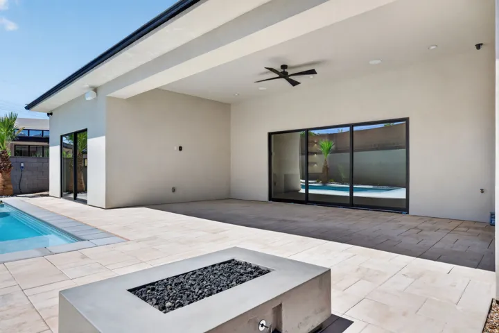 Expansive covered patio with recessed lighting, ceiling fan, and large format tile flooring