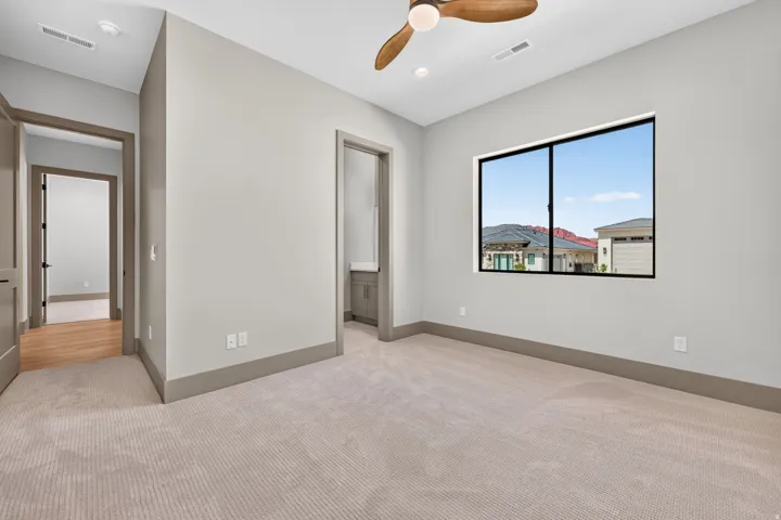 Plush carpeting, recessed lighting, ceiling fan, large window, and gray wall paint