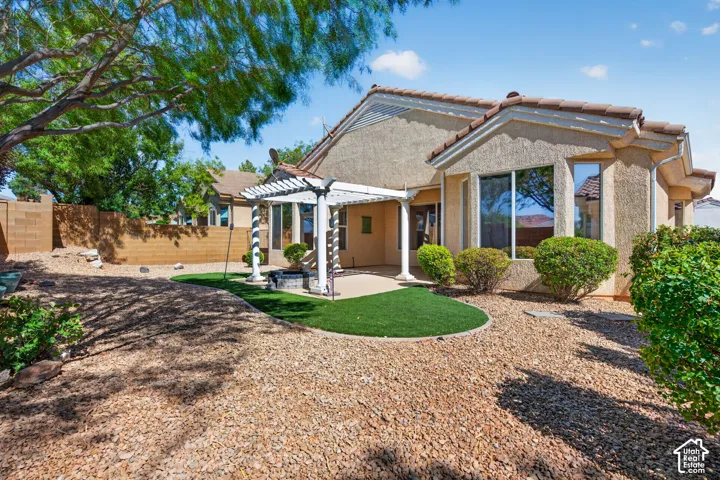 Contemporary home featuring a curved front exterior with stucco cladding, expansive windows, and a welcoming entry portico