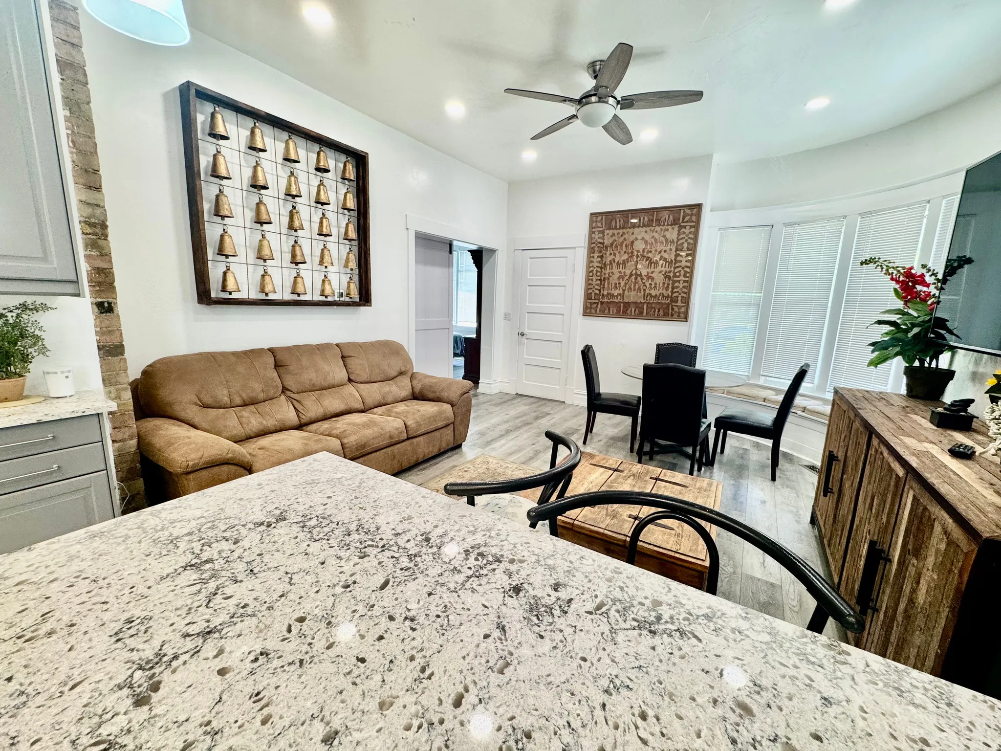 Open-concept living space featuring wood-finish flooring, recessed lighting, and a ceiling fan