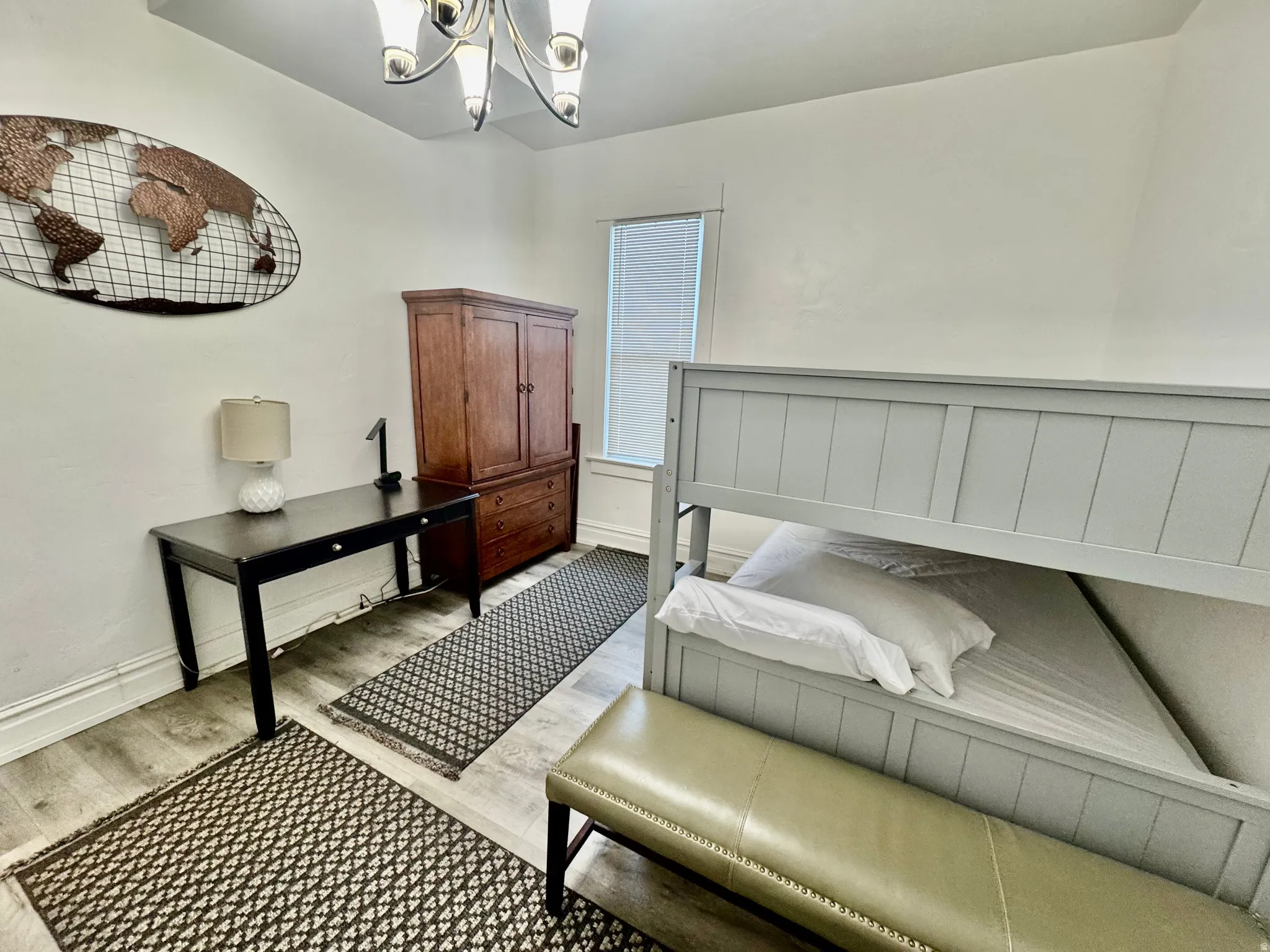 Light-toned wood-finish flooring complements white painted walls