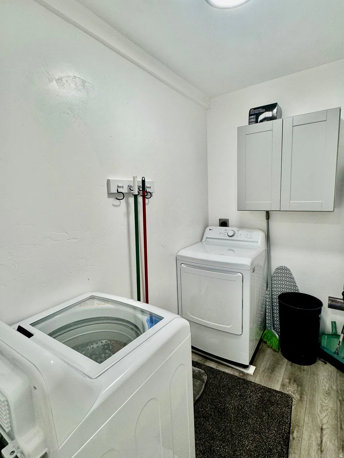 Dedicated laundry area featuring a top-loading washing machine and dryer