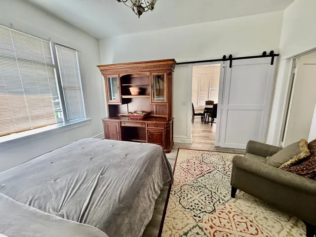 Bright interior space with light wood-finish flooring and a decorative area rug
