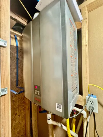 Tankless water heater installation within exposed framing