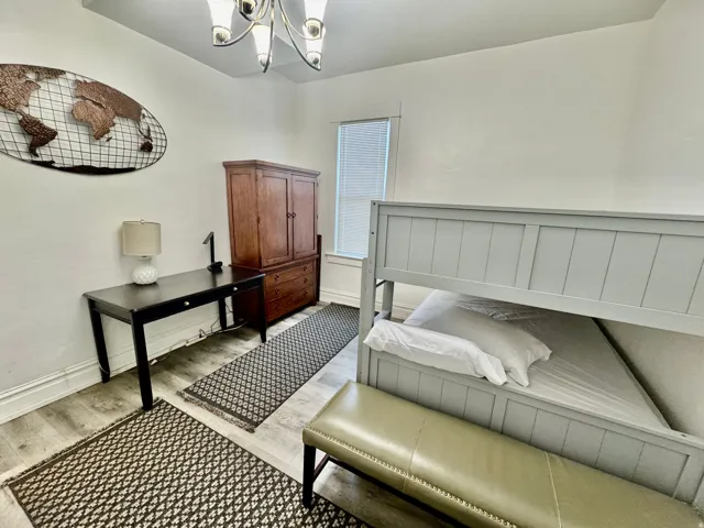 Light-toned wood-finish flooring complements white painted walls
