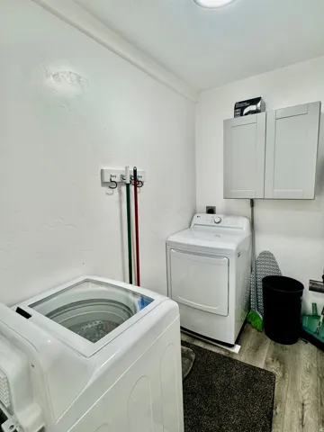 Dedicated laundry area featuring a top-loading washing machine and dryer