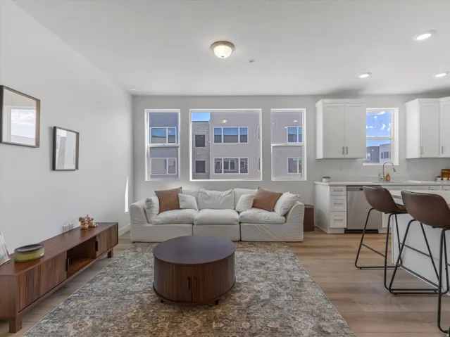 Open-concept living space with light wood-finish flooring