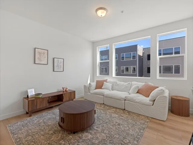 Recessed lighting, light wood-finish flooring, and multiple large windows
