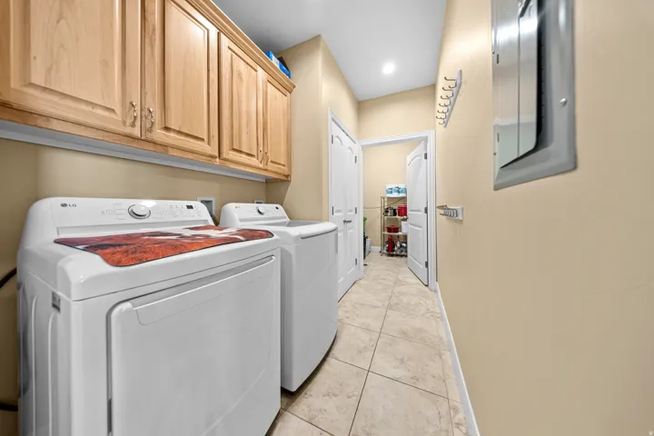 Light-toned cabinetry, tile flooring, recessed lighting, and pale yellow wall color