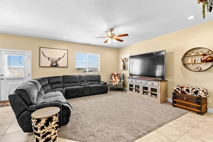 Recessed lighting, ceiling fan, and light-toned walls
