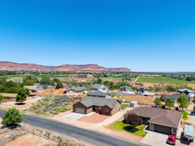 Expansive rural scenery with distant red rock formations