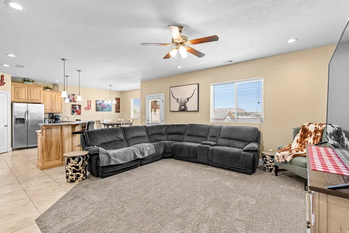 Open-concept living area with light beige walls and recessed lighting