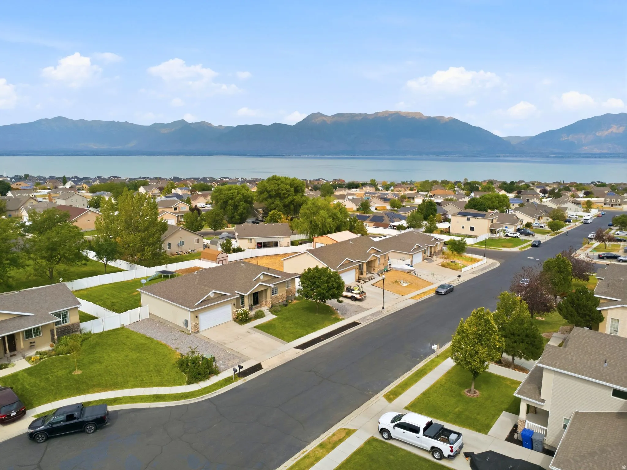 Expansive neighborhood setting with a prominent lake and mountain backdrop