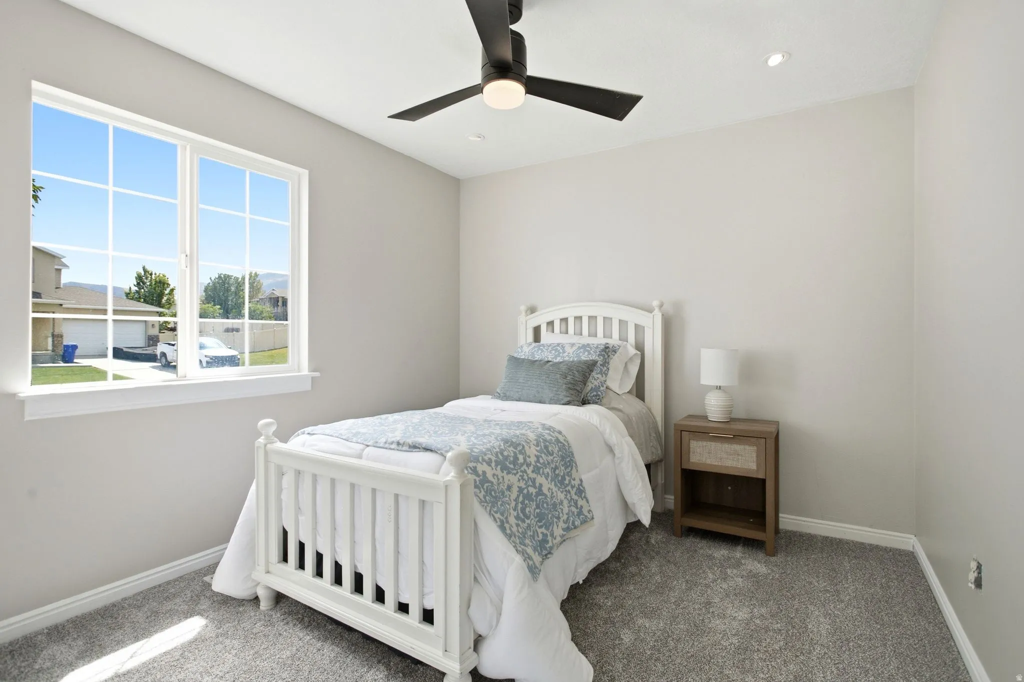 Light gray wall paint, gray carpet, white window trim, contemporary ceiling fan, recessed ceiling lighting