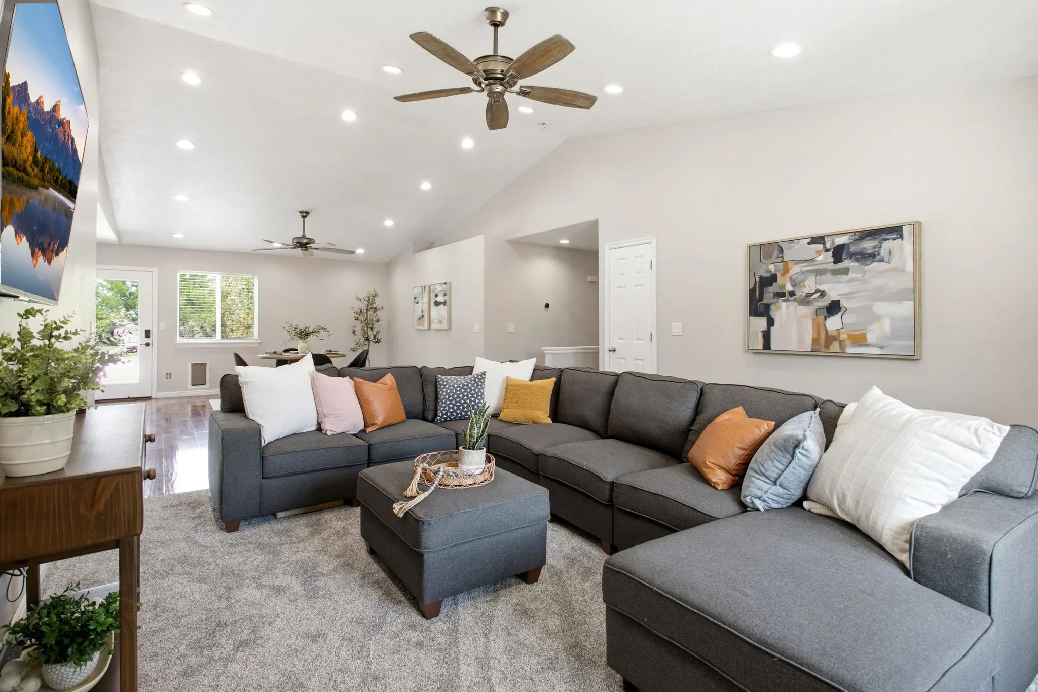 Vaulted ceilings featuring recessed lighting and ceiling fans and brand new carpet.