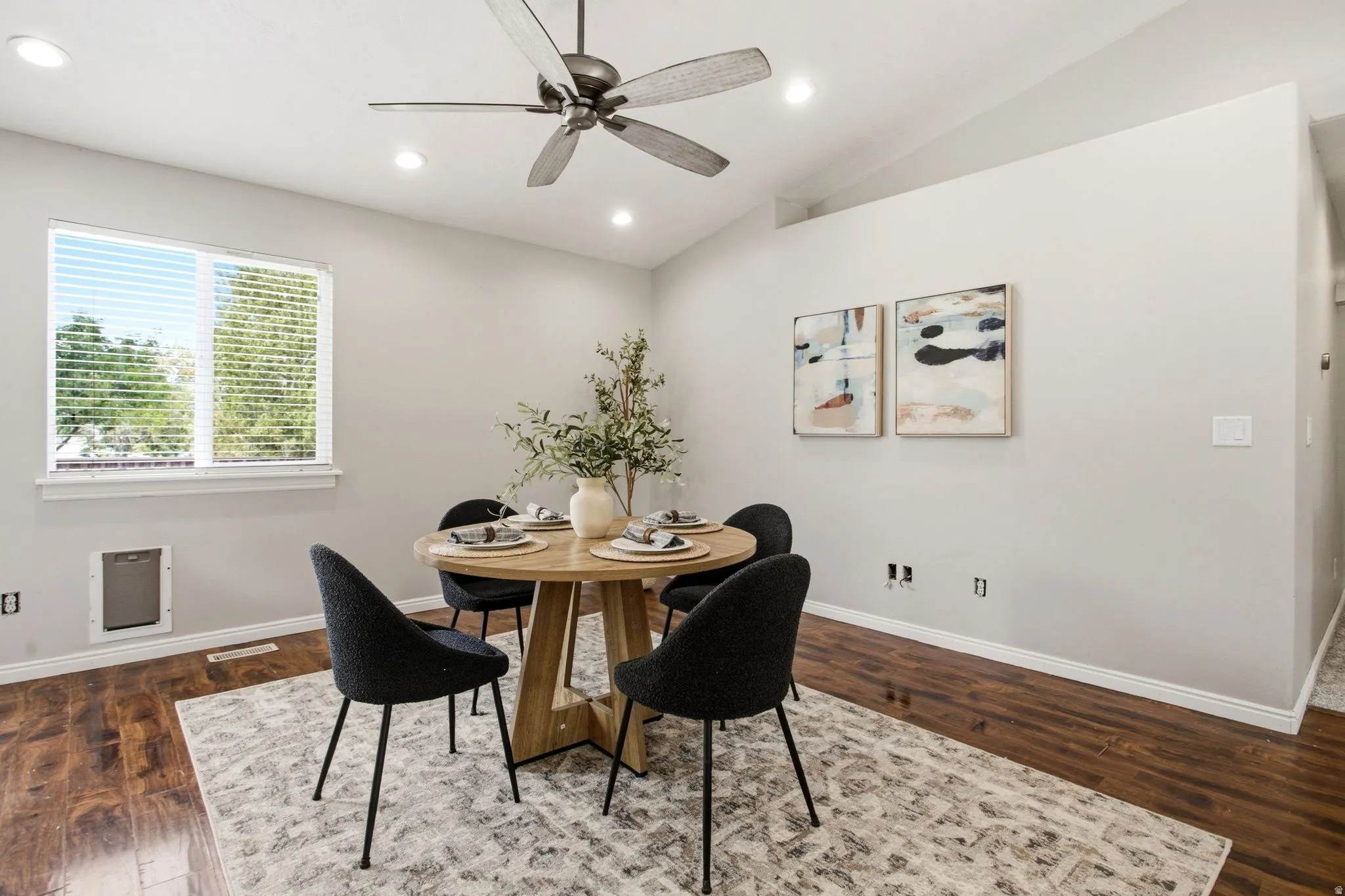 Vaulted ceilings, wood-finish flooring, recessed lighting, and a ceiling fan