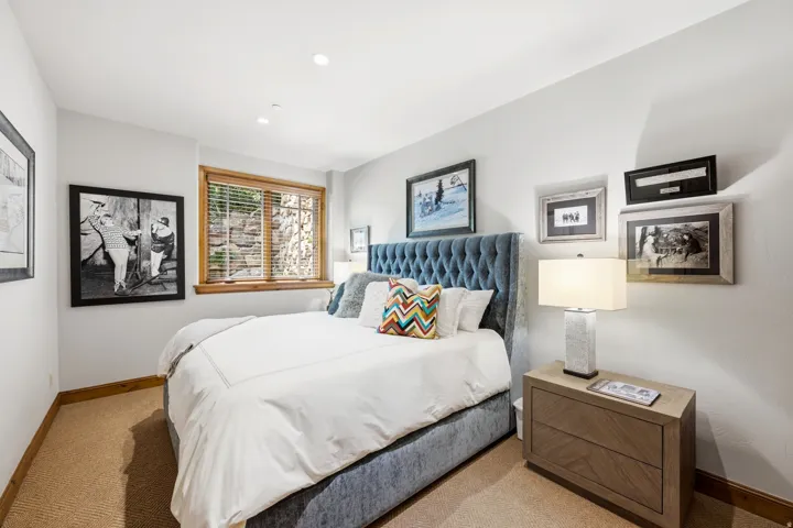 Recessed lighting, wood-trim window with blinds, and light-colored walls