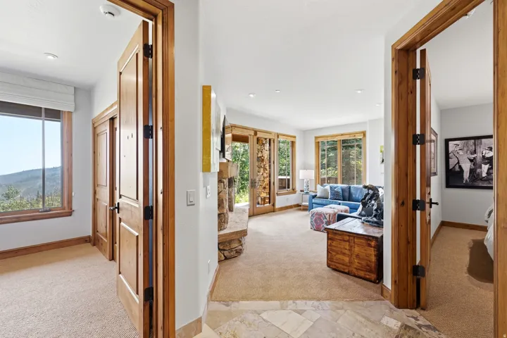 Stone tile entryway with warm wood trim and doors