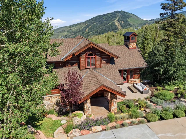 Stone and wood-sided exterior with a natural shingle roof