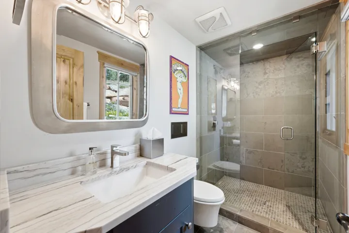 Vanity with stone countertop, rectangular undermount sink, and contemporary faucet