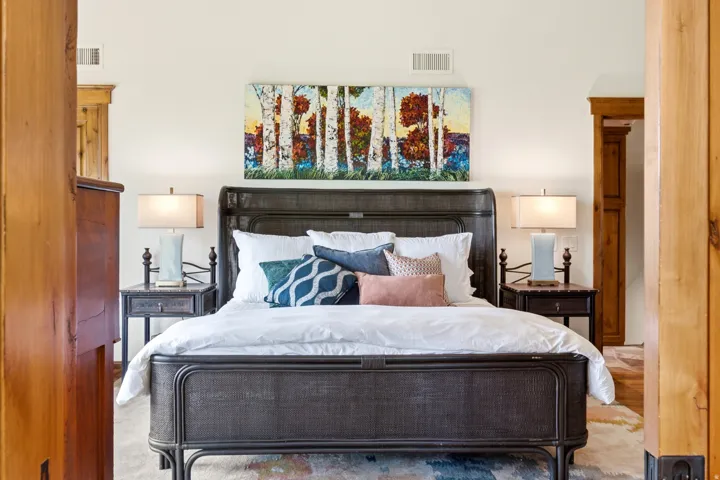 White wall finish with a dark metal bed frame