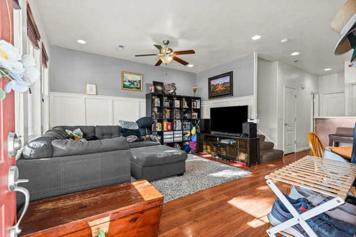Open concept living space featuring wood-finish flooring, recessed lighting, and a ceiling fan