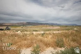 Expansive open terrain featuring natural vegetation and distant mountain ranges