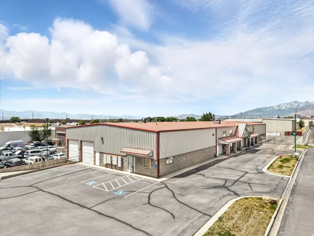 Commercial building featuring a metal roof, corrugated metal siding, and a stone facade