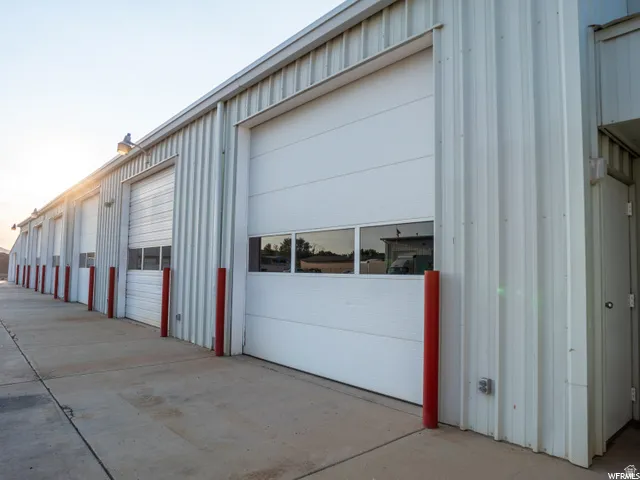 Corrugated metal exterior with multiple roll-up doors featuring window panels