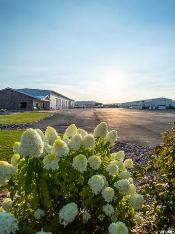 Paved drive with multiple commercial buildings featuring stone and siding exteriors, and metal roofs