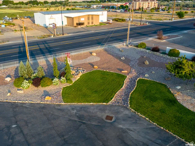 Landscaped grounds featuring patterned gravel and green lawn areas