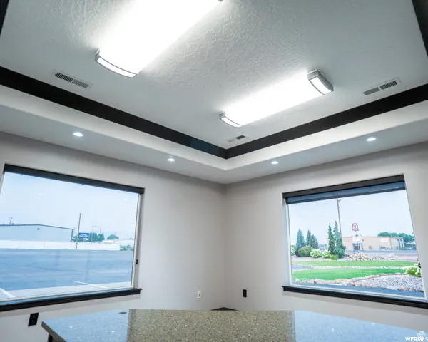 Tray ceiling with recessed lighting and linear ceiling fixtures