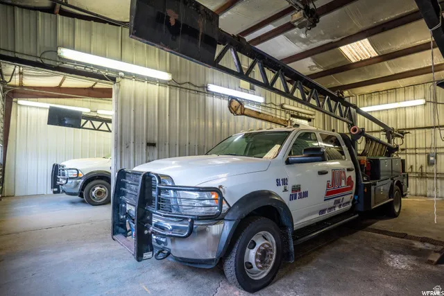 Metal-clad interior walls, concrete flooring, overhead fluorescent lighting, and exposed structural beams