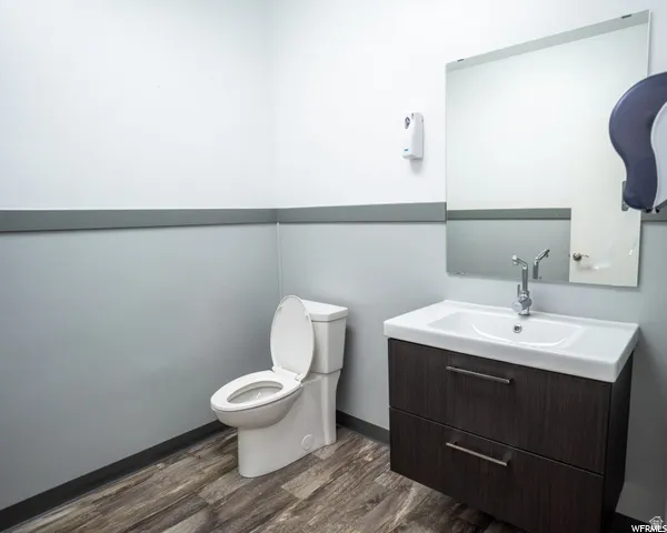 Modern vanity with two storage drawers, white rectangular basin, polished chrome faucet, and a wall-mounted mirror